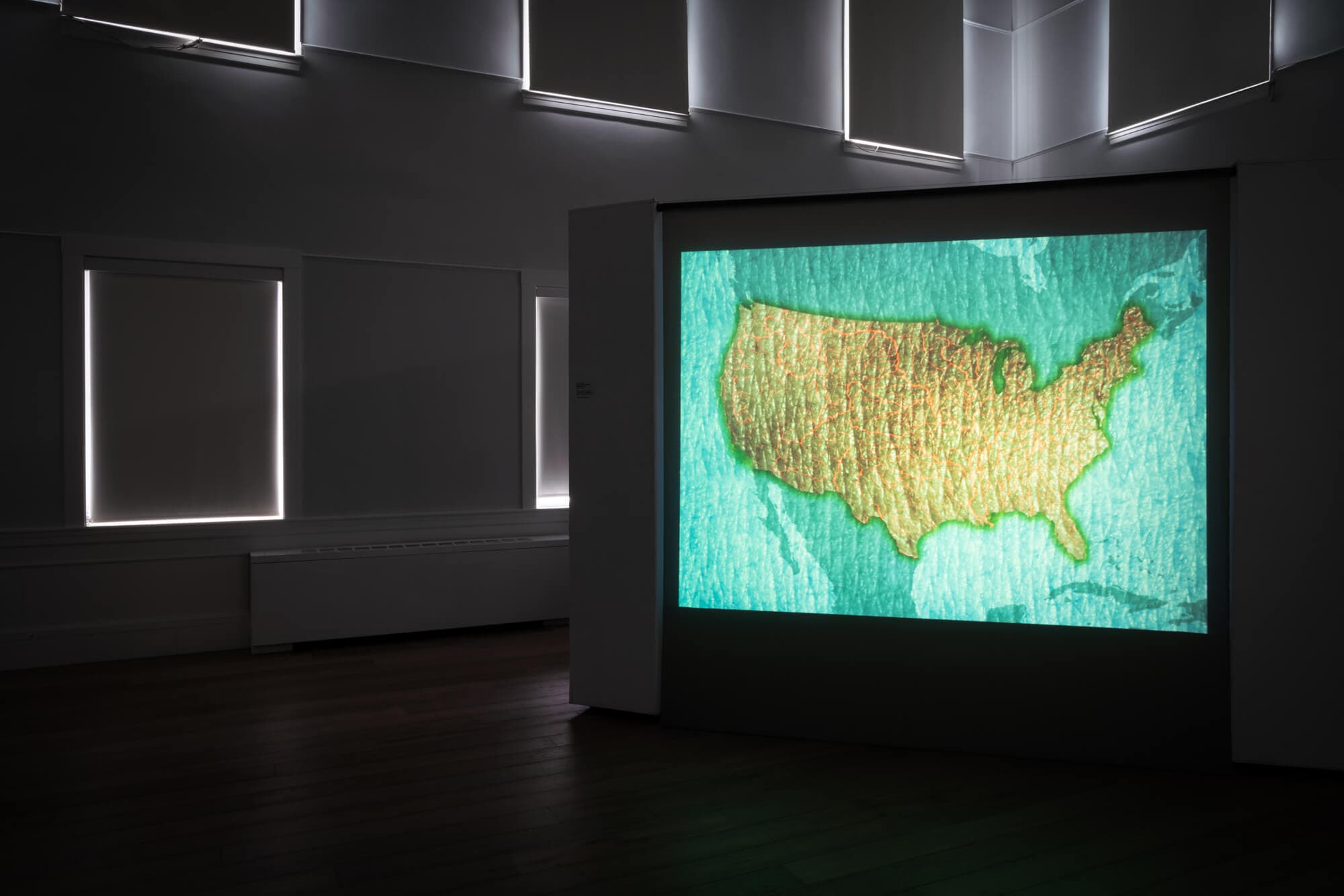 Installation image of "Surface Tension", in a dark room.